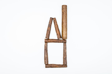 House with pipe made of twisted cigars on white background.