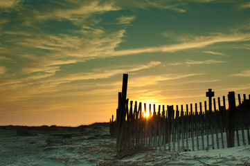 Warm Sunset over white sandy beach with boardwalk