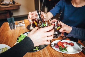 Young ladys enjoying time together in cafe, friends drinking cold drinks and eat breakfasts together.