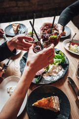 Young ladys enjoying time together in cafe, friends drinking cold drinks and eat breakfasts together.