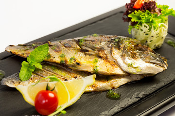Grilled sea fish. Close-up shot on a white background.