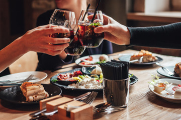 Young ladys enjoying time together in cafe, friends drinking cold drinks and eat breakfasts together.