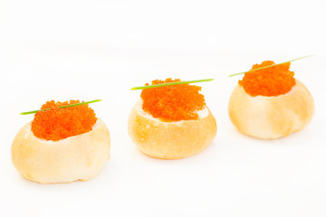 Snacks and canapes on the banquet table, closeup shot on a white background.