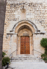 Fototapeta na wymiar Entrance doors to the Benedictine Abbey of Abu Gosh in the Chechen village Abu Ghosh near Jerusalem in Israel