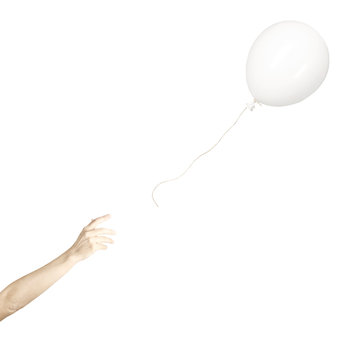hand lets fly away a white balloon, concept of freedom