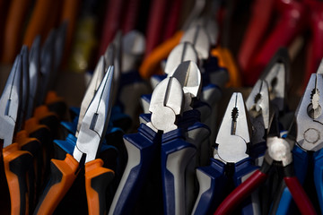 Background tools electrician fitter pliers nippers close-up.