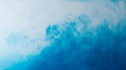 Blurred colors are melting in water to be blue background