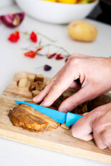 man cutting a piece of seitan