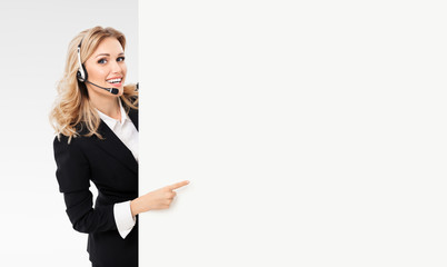 Portrait of support phone operator in black confident suit and headset showing blank signboard with...
