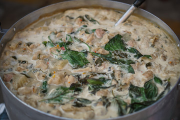 Green curry with fish in big pot.