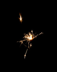 Burning sparkler isolated on black background