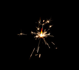 Fototapeta premium Burning sparkler isolated on black background