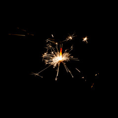 Fototapeta premium Burning sparkler isolated on black background