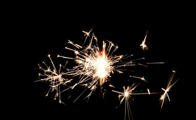 Burning sparkler isolated on black background