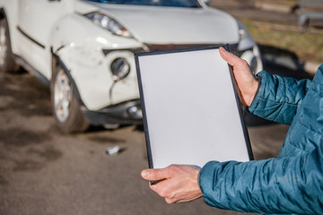 Space for text, blank document close up. An insurance agent will inspect and inspect vehicle damage after an accident.