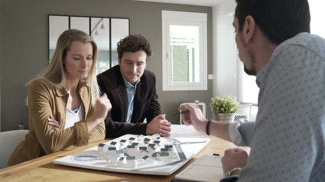 Architect meeting with clients to present real-estate project