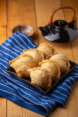 Homemade chicken Curry puffs on wooden table