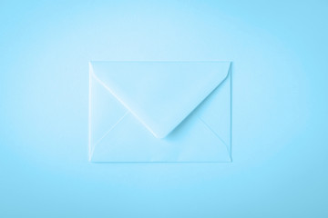 Light soft pale blue envelope on blue background. Minimal concept