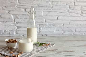 Organic Almond milk in glass with almond nuts. Healthy eating concept.