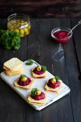 Beetroot relish on crackers. An original party snack.