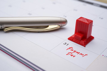 Mortgage payment due on the end of every month. image with pen and calendar 