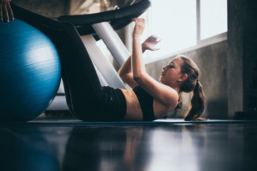 Fototapeta na wymiar young woman exercising in the sport gym