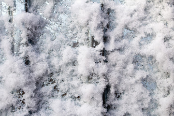 Snow frost on metal. A sheet of metal in the cold was covered with the texture of blue frost.