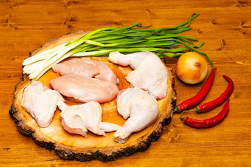 Butchered chicken carcass on a wooden background