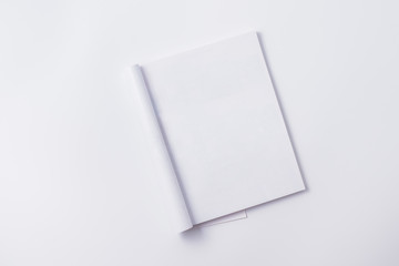Flat lay mockup with white open magazine on a white background