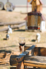 glass of wine on wooden well