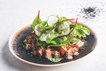 Vegan tofu poke bowl with baby chard and quinoa