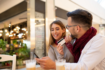 A couple deciding what to buy over a smart-phone app.