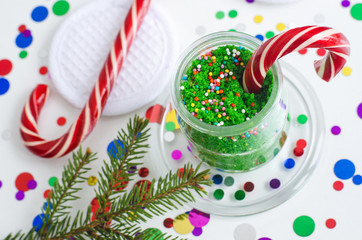 DIY green peppermint sugar scrub (aroma bath salts, foot soak) in a glass jar. Handmade New Year gift. Christmas spa and beauty treatment. Selective focus, copy space.