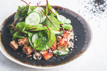Vegan tofu poke bowl with baby chard and quinoa
