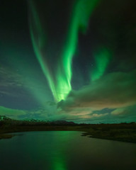 Northern lights over a lake in winter in Iceland