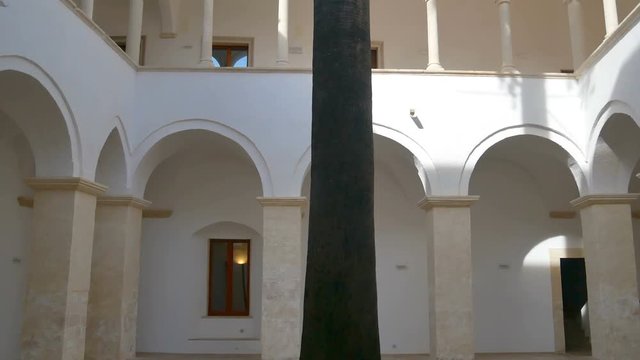 Vertical overview of the cloister of an ancient convent used as the seat of the town hall of Modugno, Apulia - Italy