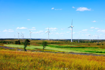 Asphalt road and wind turbines