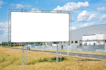 Blank white billboard for advertisement in the front of industrial building.