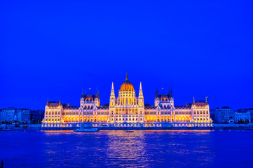 Fototapeta premium The Hungarian Parliament Building located on the Danube River in Budapest Hungary at sunset.