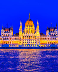 Fototapeta premium The Hungarian Parliament Building located on the Danube River in Budapest Hungary at sunset.