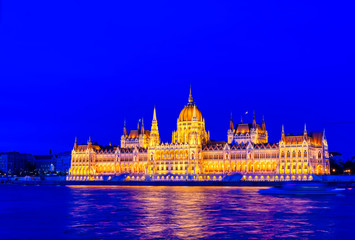 Fototapeta premium The Hungarian Parliament Building located on the Danube River in Budapest Hungary at sunset.