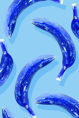 Photography contemporary art collage.Modern abstract pop-art holographic neon blue color inversion banana pattern fruit background.Surrealism and minimalism poster.Vertical orientation