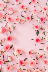 Fototapeta na wymiar Round frame border of pink rose flower buds on pink background. Mockup blank copy space. Flat lay, top view floral composition.