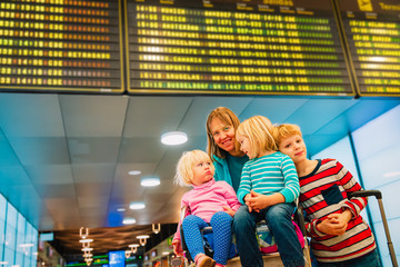 mother with three kids travel in the airport, family travel