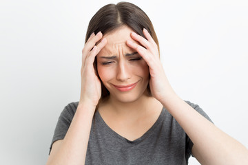 Headache, fatigue, stress in a woman. The depressive state of a girl on a white background.