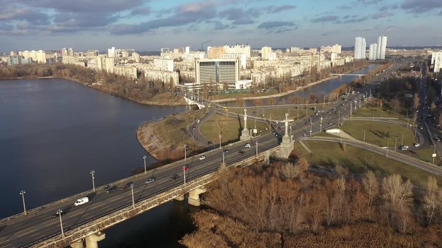 Beautiful Aerial View of City Traffic on the Bridge. City Traffic on the Patona Bridge. View of Rusanovskaya Embankment.