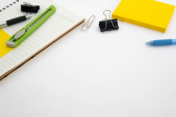 post it note, pen, cutter, note pad and clipper in isolate white background with space for text. office stationary equipment concept.