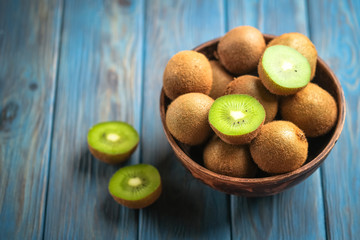 Kiwi fruit  in bowl on  blue wooden rustic table, ingredient for detox smoothie.