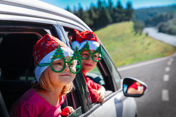 christmas car travel- happy boy and girl travel in winter