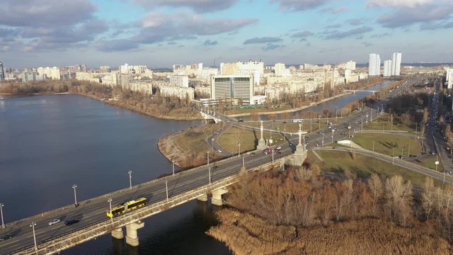 Beautiful Aerial View of City Traffic on the Bridge. City Traffic on the Patona Bridge. View of Rusanovskaya Embankment.